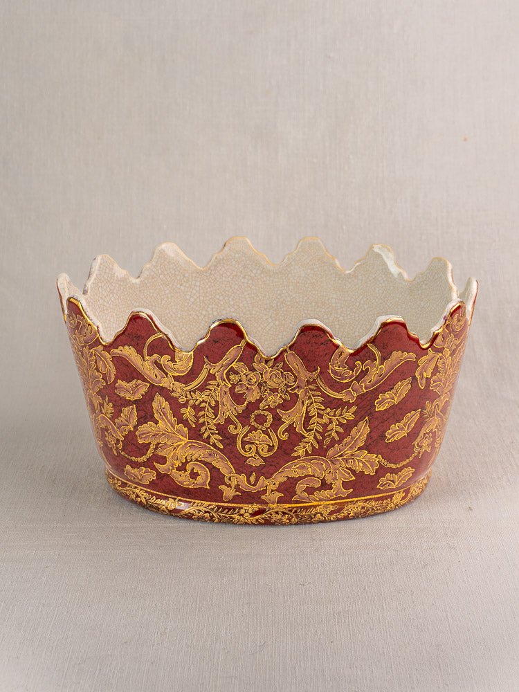 Late 19th-century French ceramic wine cooler with red and gold floral motif, scalloped edge, cream crackle interior.