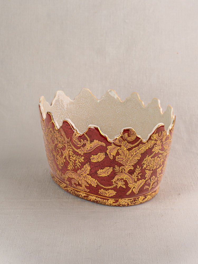 Antique French Terre de Fer wine cooler with scalloped ceramic rim, red base, and gold floral design.