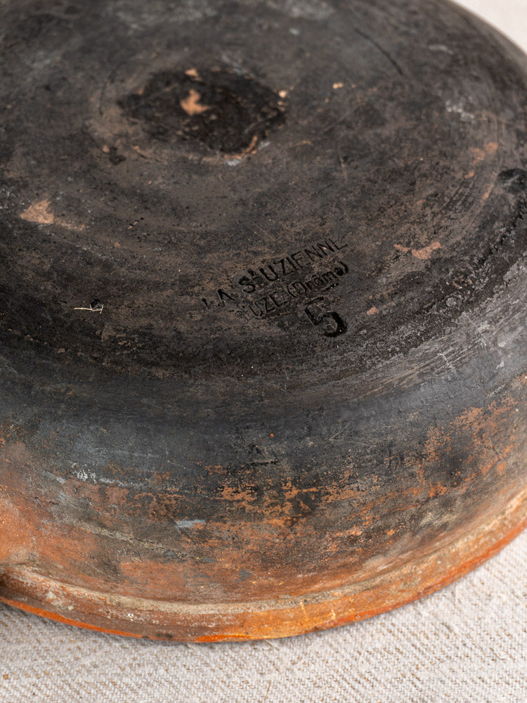 Antique French Saint-Uze stoneware poêlon underside with LA SUIZERA and 5 stamp, weathered patina.