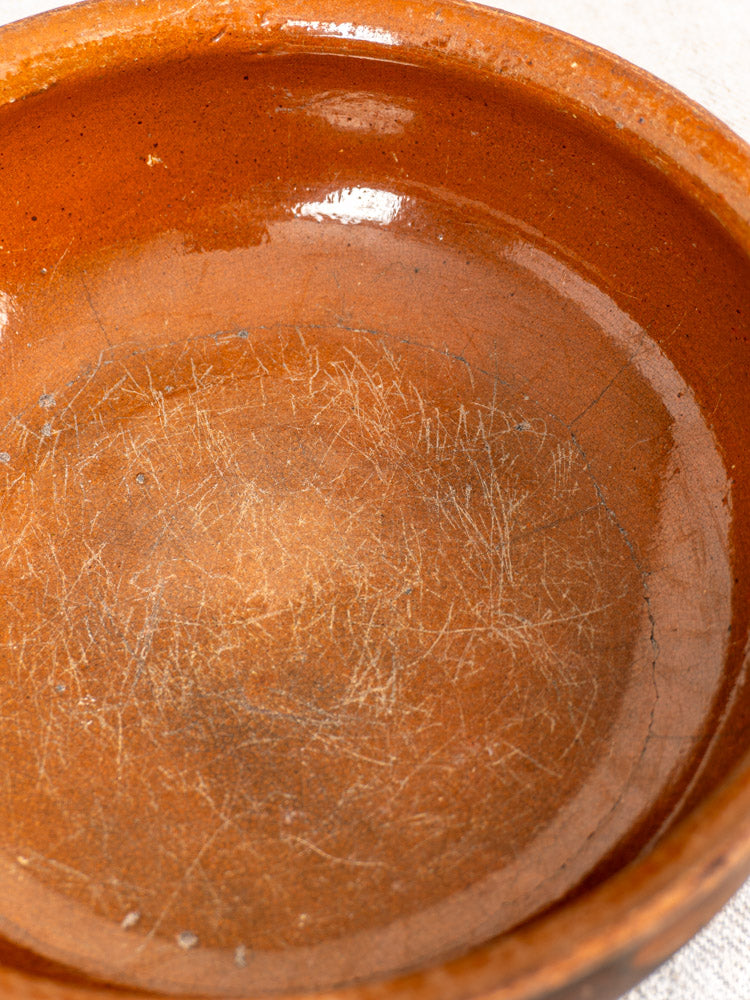 Antique French Saint-Uze stoneware pan with brown glaze, visible crackle, glossy finish, and aged patina.