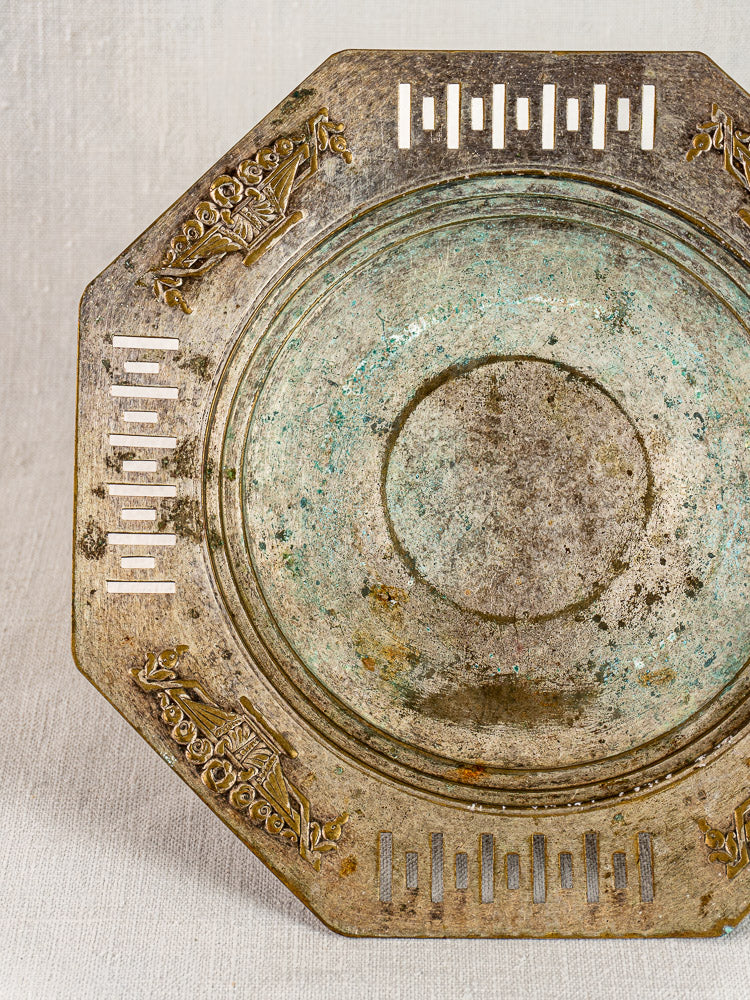Art Deco French silver plate tazza with octagonal footed coupe and floral engraved rim on light fabric.