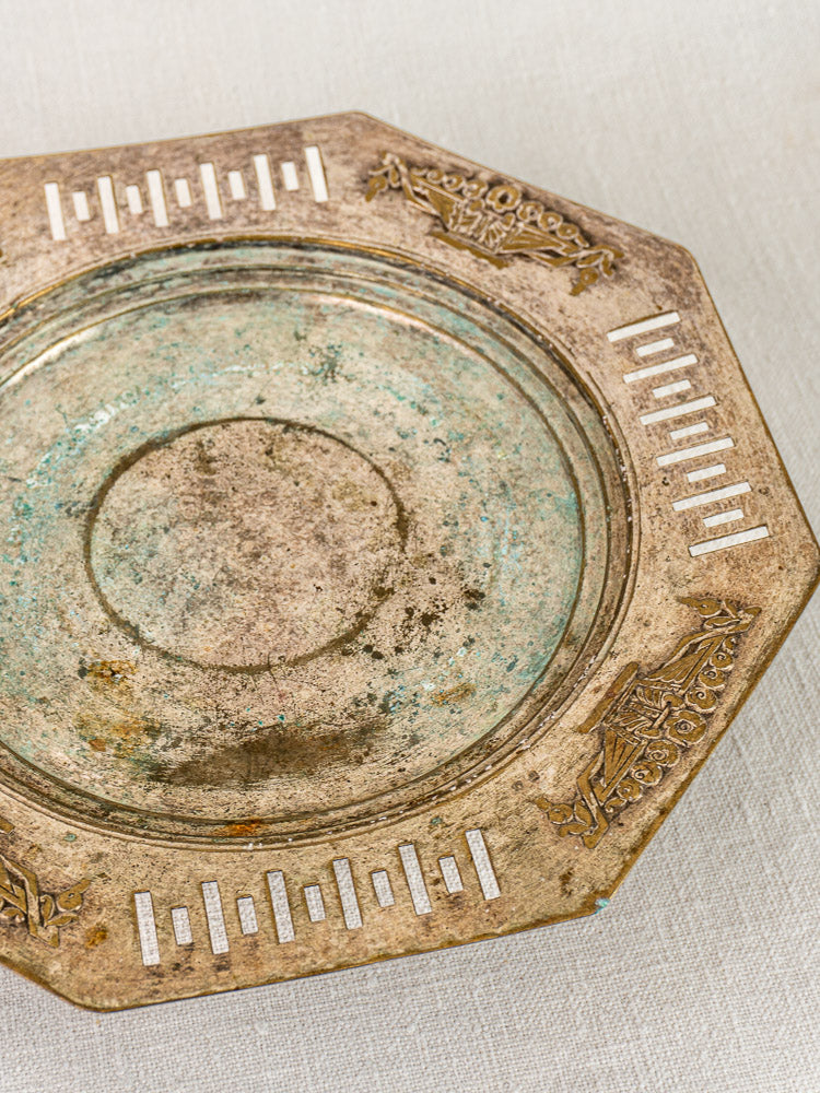 Octagonal French Art Deco silver plate tazza with patterned design and white inlays on fabric surface.