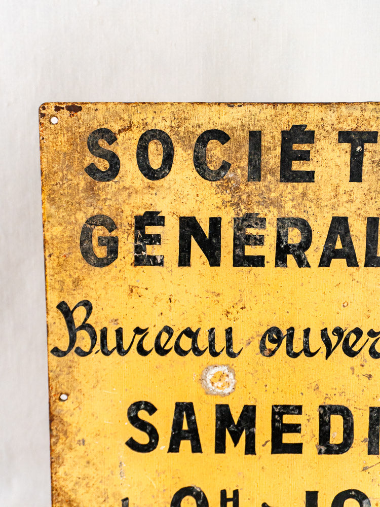 Antique yellow French Société Générale bank sign, hand-painted steel with aged black lettering and visible rust.
