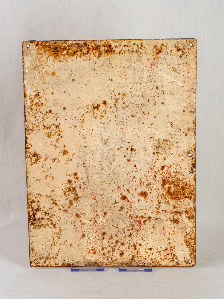 Antique hand-painted French steel plaque with four corner holes, aged with rust spots and patina.