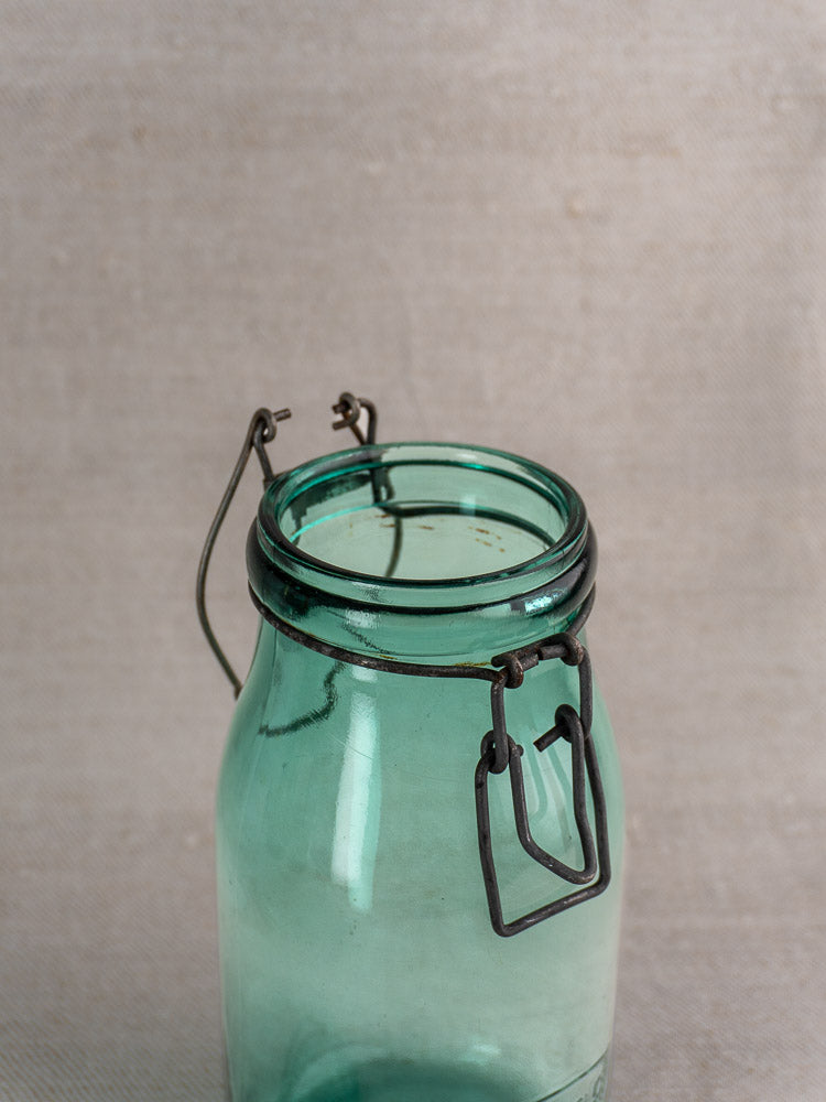 Set of three antique French Solidor & Durfor preserve jars with hinged wire clasps, displayed open on neutral fabric.