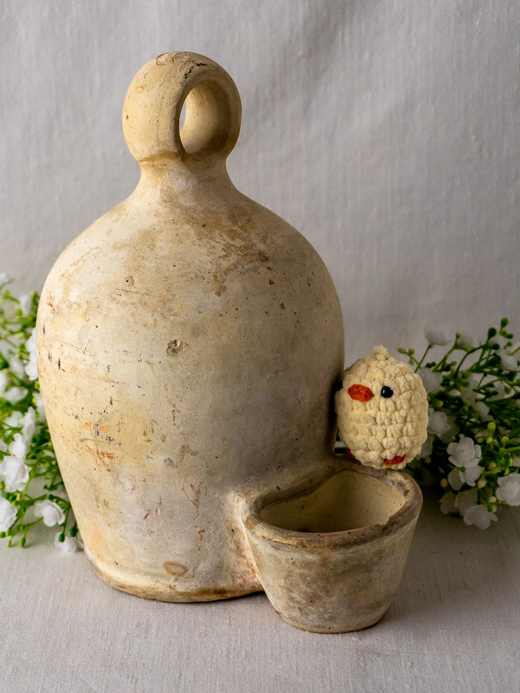 Antique French grès bird waterer in rustic beige ceramic with handle and matching cup, vintage details.