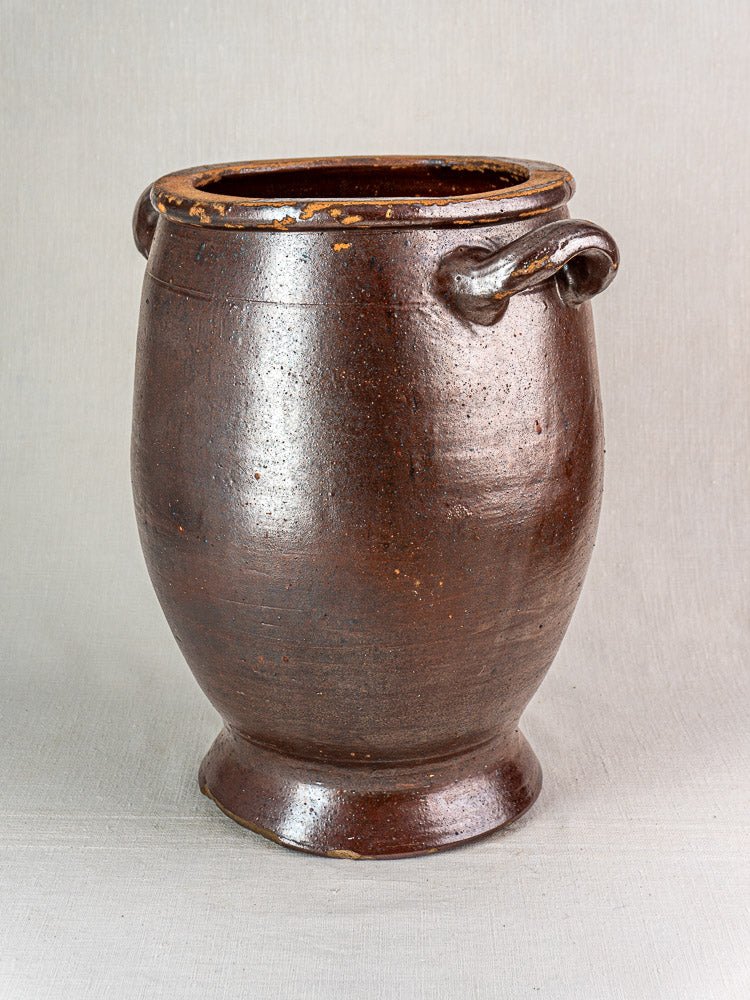 Large antique French salt-glazed stoneware storage jar with brown glaze, loop handles, and wide mouth.