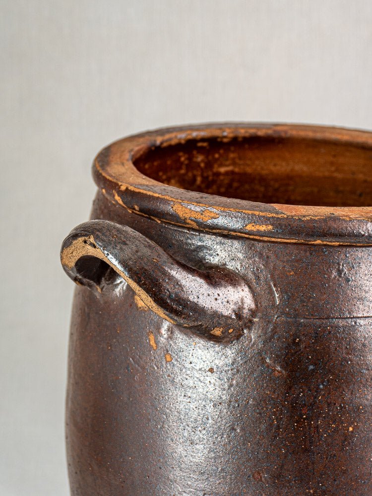Antique French salt-glazed stoneware Pot à Graisse with weathered brown ceramic and curved handle.