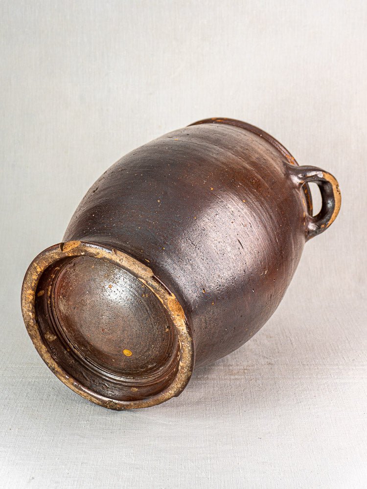 Large antique French storage jar in salt glazed stoneware with textured, aged surface and two top handles.