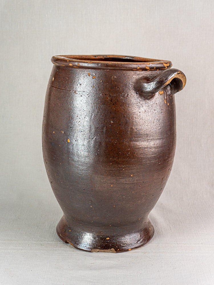 Antique French Pot à Graisse storage jar in salt glazed stoneware with single handle, neutral background.