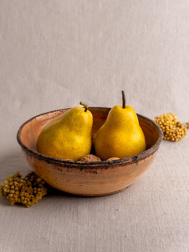 Antique French yellow glazed earthenware Tian baking dish, late 19th century, on light gray fabric.