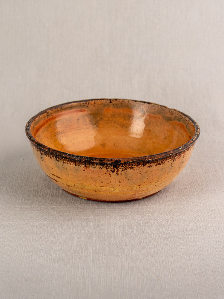 Antique French yellow glazed earthenware Tian baking dish, late 19th century, on light gray fabric.