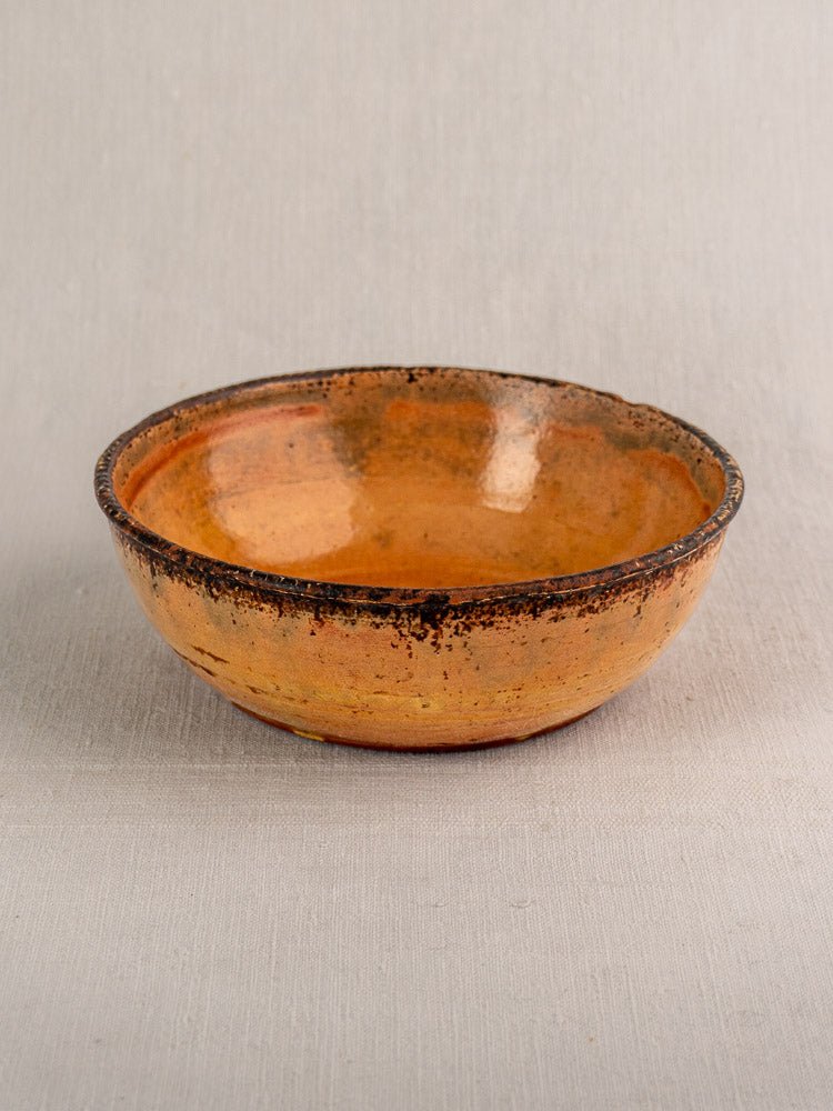 Antique French yellow glazed earthenware Tian baking dish, late 19th century, on light gray fabric.