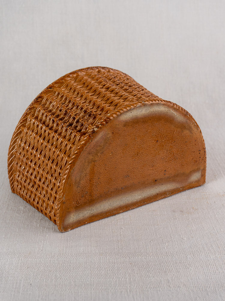 Antique French salt-glazed stoneware salt box, half-cylinder with woven texture, farmhouse accent on neutral fabric.