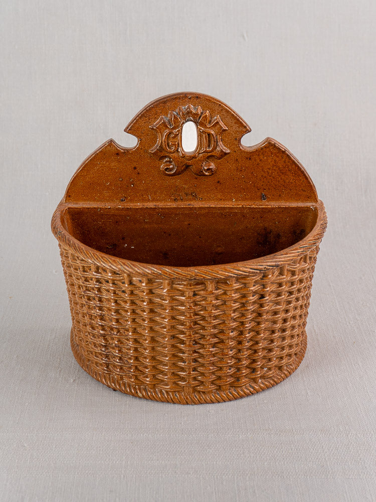 Antique French salt-glazed stoneware salt box with woven basket texture, arched top, and keyhole hanger.