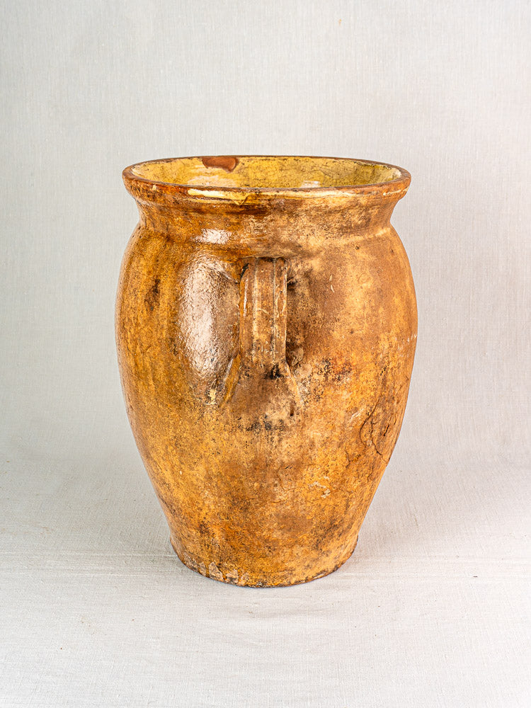 19th-century French terracotta storage jar with round brown ceramic body, wide mouth, and yellow glazed interior.