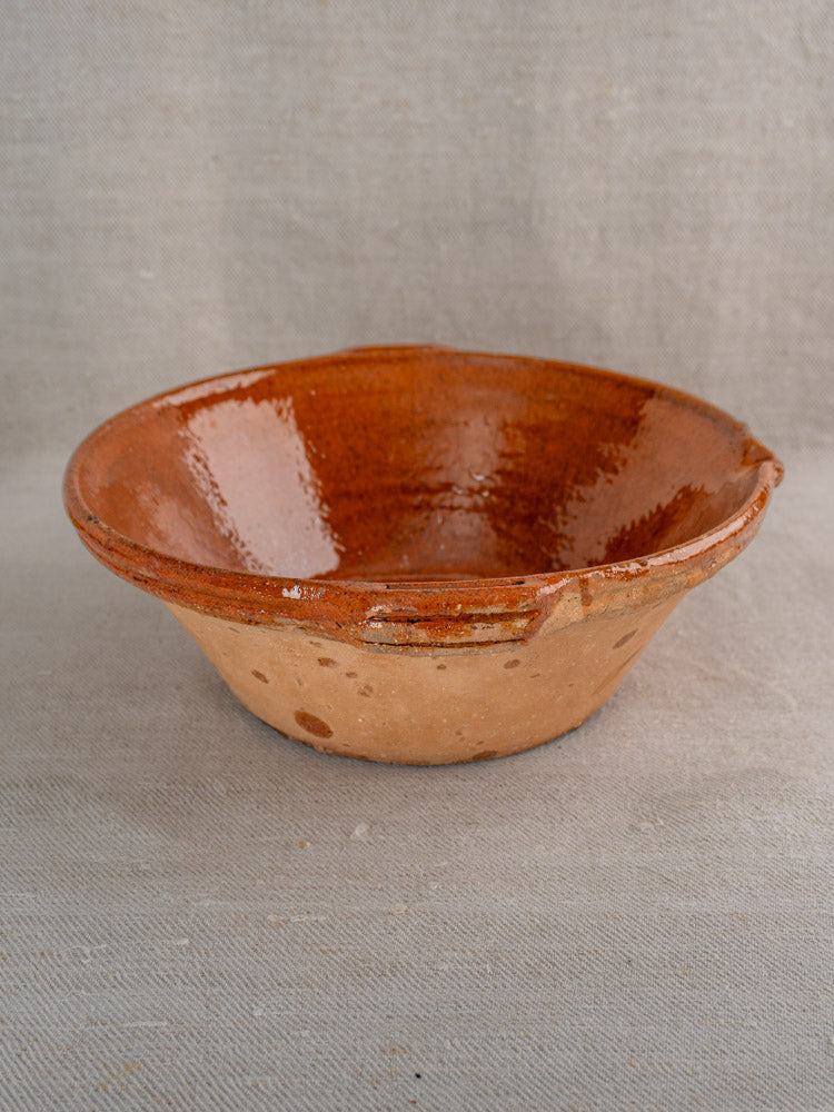Pair of antique French Languedoc tian bowls in glazed earthenware with rich interiors, on neutral fabric.