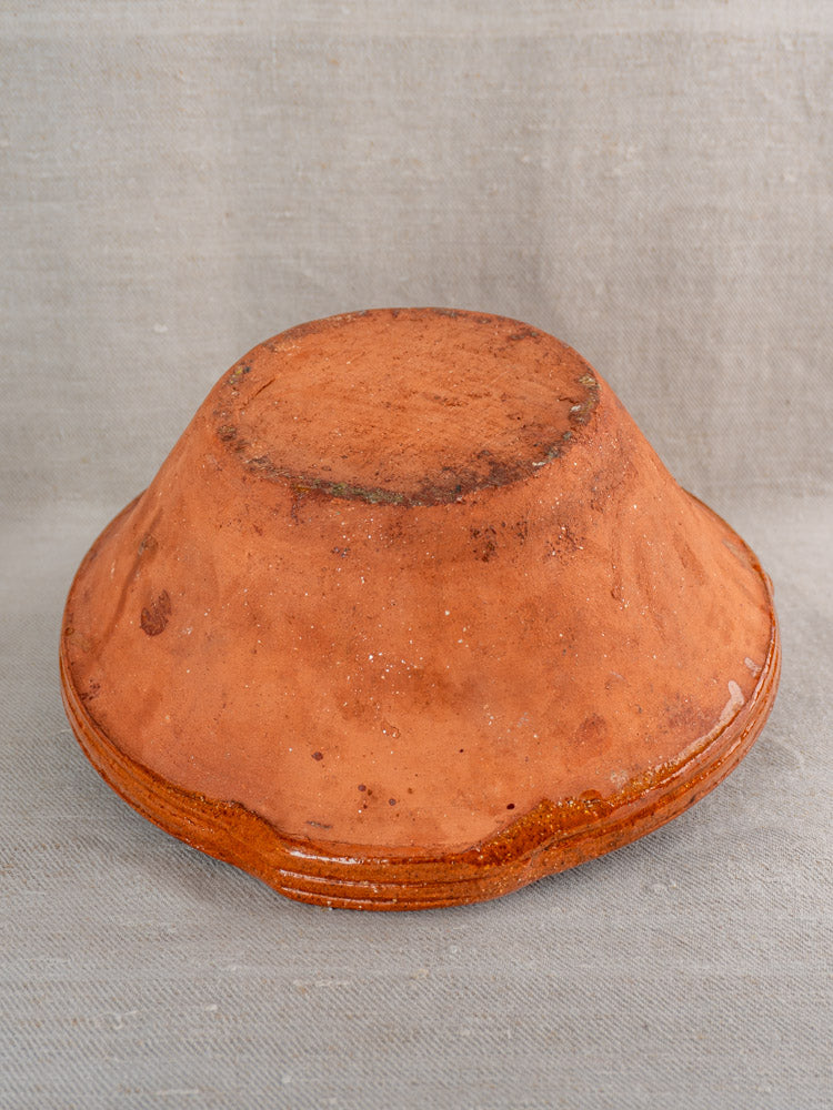 Pair of antique French Languedoc Tian bowls in glazed earthenware on neutral fabric background.