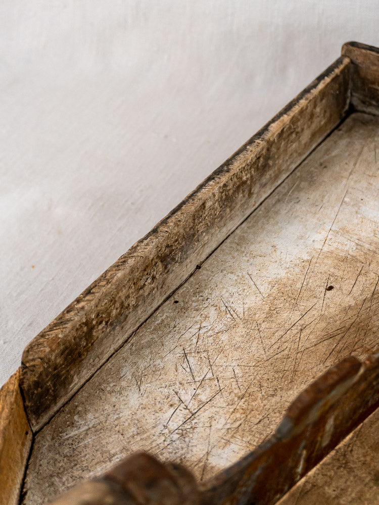 Antique French wood and iron tobacco cutter with rectangular tray and handle on light surface.