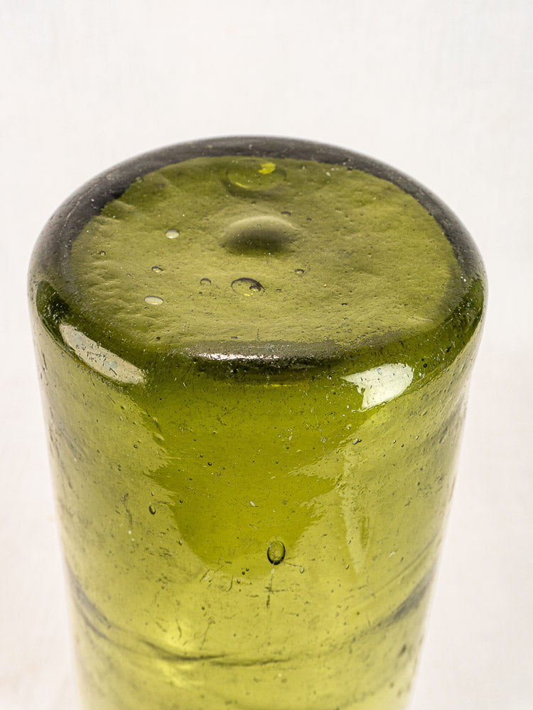 Antique French truffle bottle base in hand-blown olive green glass with domed center and air bubbles.
