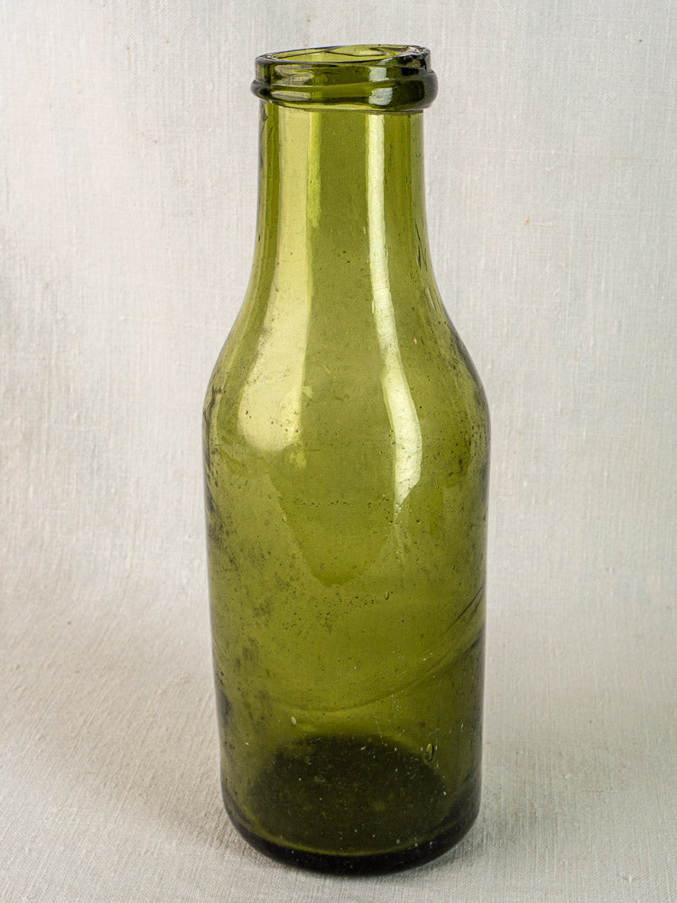 Antique French truffle bottle in hand blown olive green glass with short neck, 19th century.