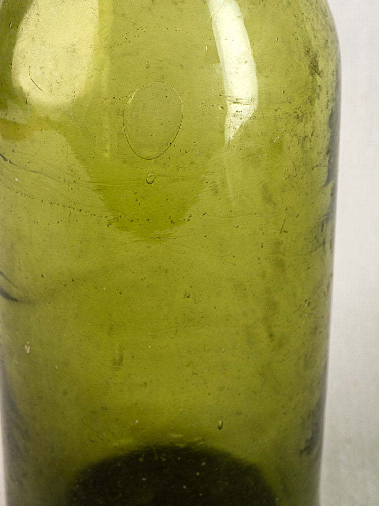 Antique French truffle bottle in hand blown olive glass with 19th-century bubbles and imperfections.