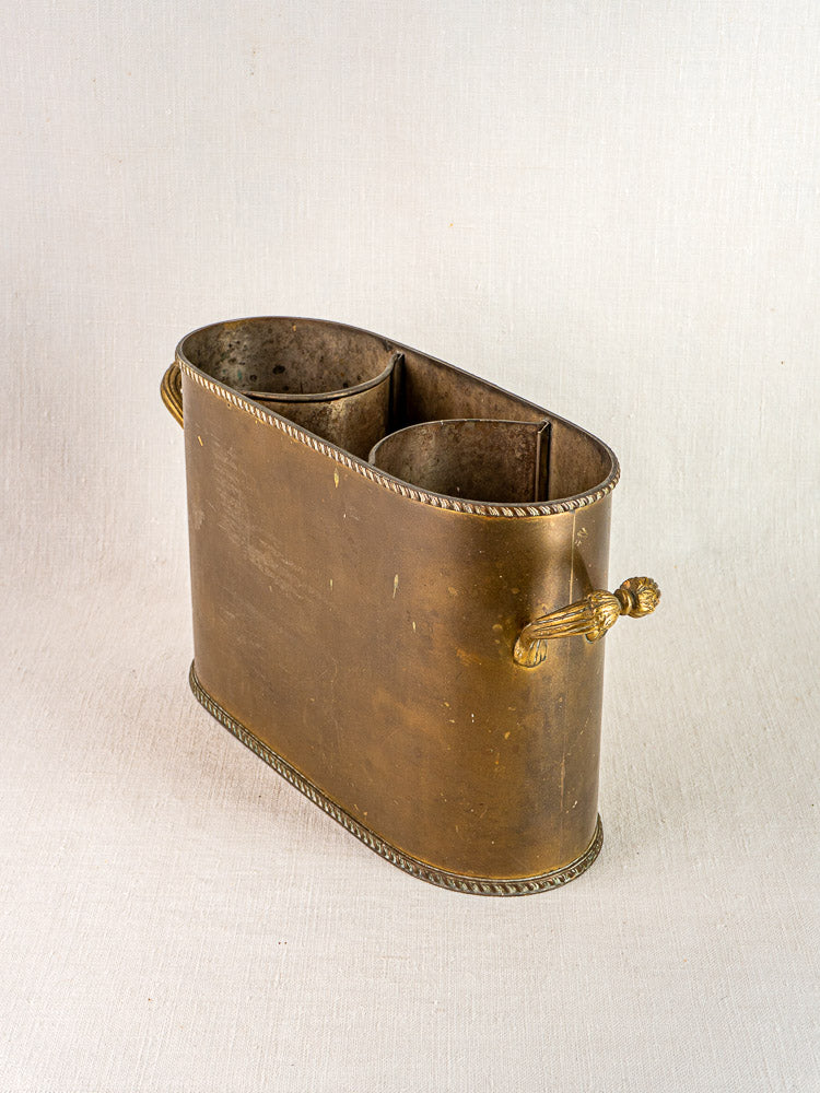 Antique French brass double champagne cooler with oval shape, ornate handles, and rope trim.