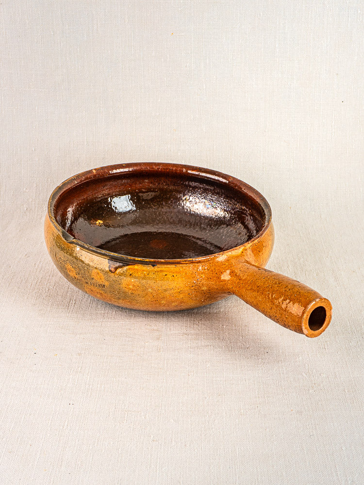 Antique French Vallauris poêlon, brown-glazed terracotta, circa 1900–1930s, single cylindrical handle.
