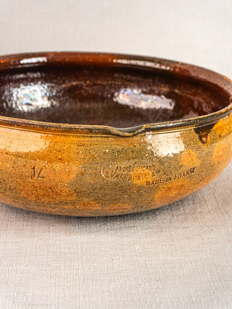 Antique French Vallauris terracotta poêlon with brown glaze, chipped rim, “MADE IN FRANCE” stamp.