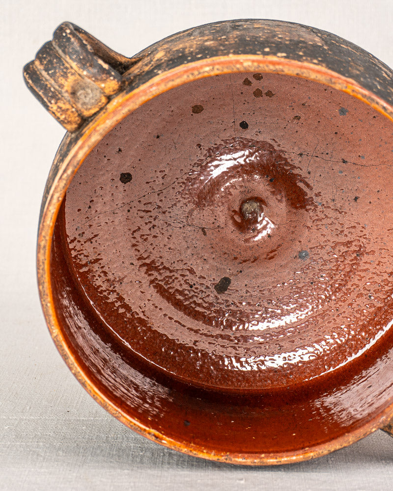 Vintage French Vallauris cooking pot, early 20th-century glazed terracotta with single handle and speckled rustic finish.
