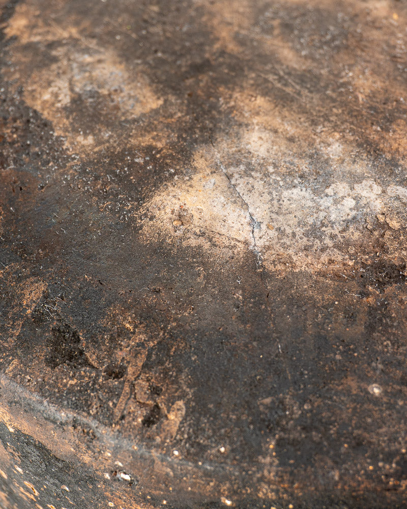 Vintage French Vallauris glazed terracotta cooking pot with rich, weathered patina in brown, black, and ashy white patches.