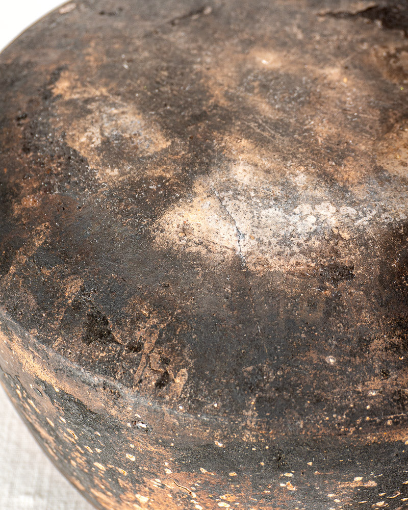 Vintage French Vallauris terracotta cooking pot with weathered dark brown glaze and textured, worn surface.
