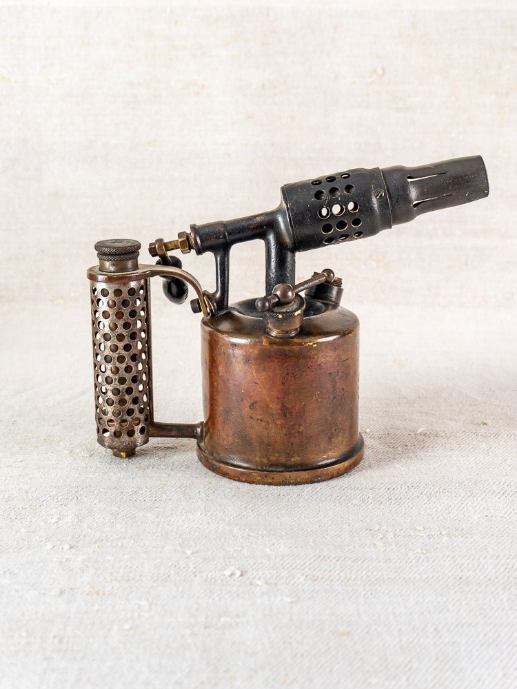 Antique French Vesta F.J. Paris blowtorch, 1920s, metal tank and perforated handle on fabric.