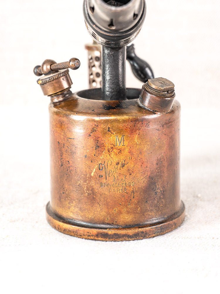 Antique French Vesta F.J. Paris brass blowtorch, circa 1920, with engraved markings and tarnished patina.