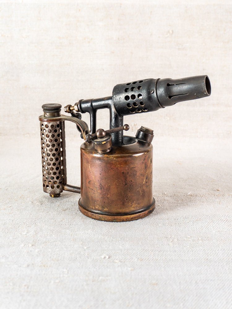 Antique French blowtorch by Vesta F.J. Paris, circa 1920, brass body, on neutral surface.