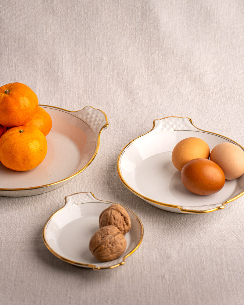 Set of three 19th-century French Vieux Paris porcelain serving dishes with gold rims and handles.