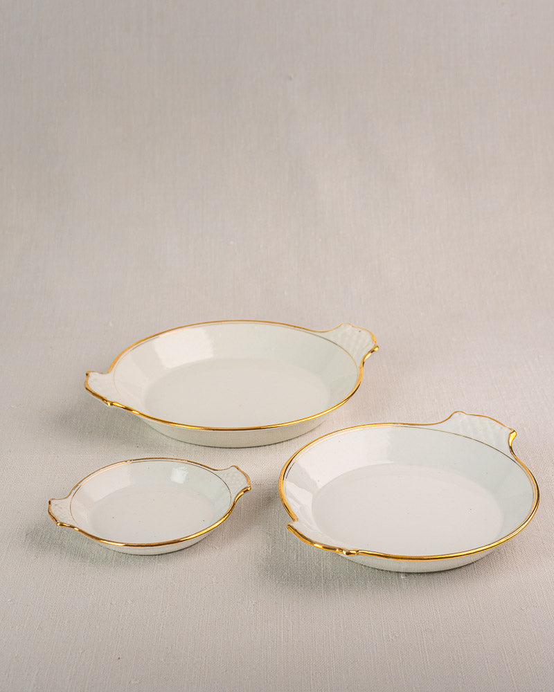 Set of three 19th-century French Vieux Paris porcelain serving dishes with gold rims and handles.