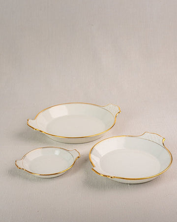 Set of three 19th-century French Vieux Paris porcelain serving dishes with gold rims and handles.