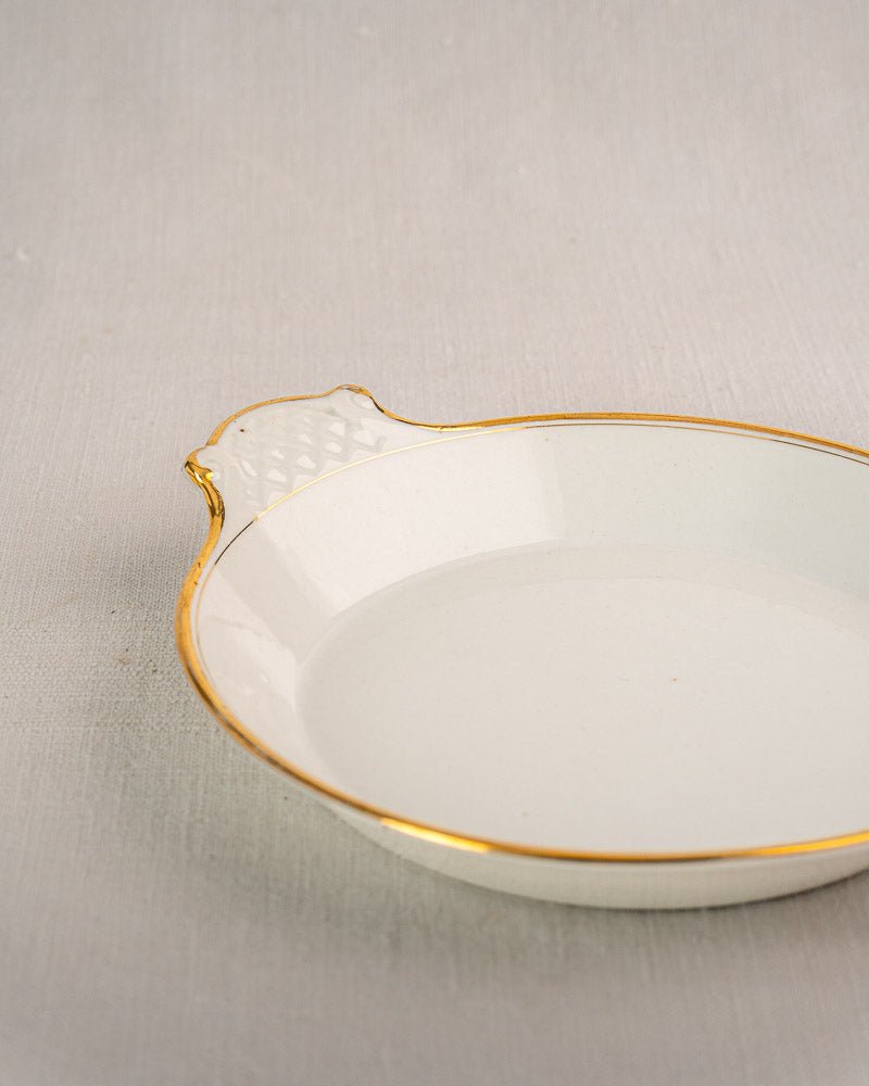 Set of three antique French Vieux Paris porcelain serving dishes with gold trim on a textured surface.