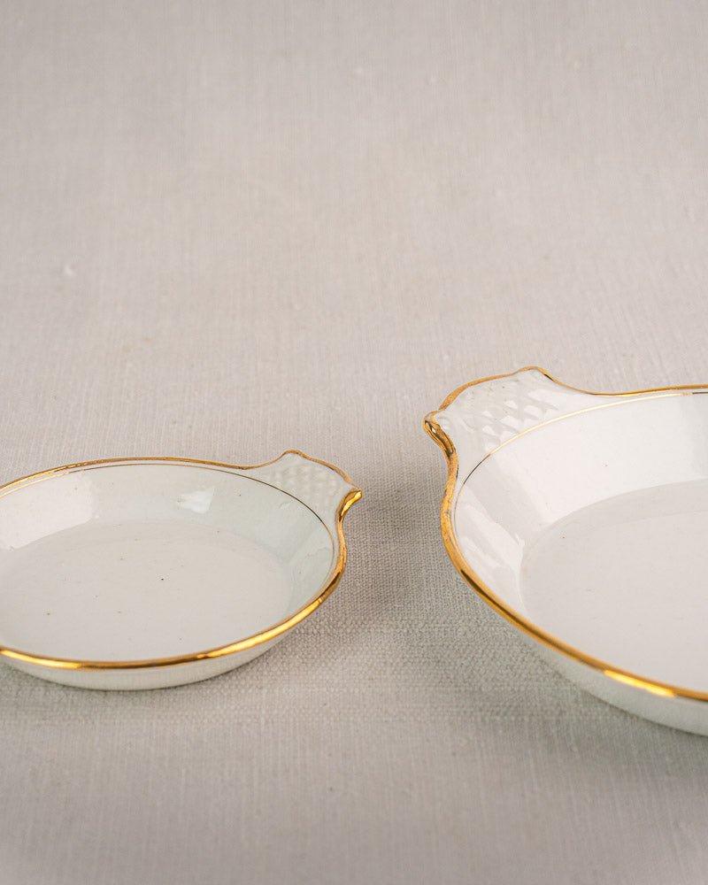 Set of three 19th-century French Vieux Paris porcelain serving dishes with gold rims on neutral surface.