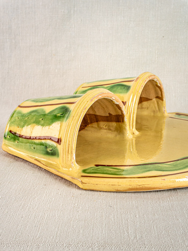 Vintage French Cliousclat cutlery holder in yellow and green glazed earthenware, Provençal style, on neutral fabric.