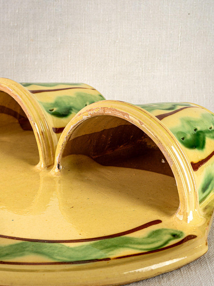 Vintage French Cliousclat cutlery holder, terre vernissée Provençal pottery, yellow and green, on fabric background.