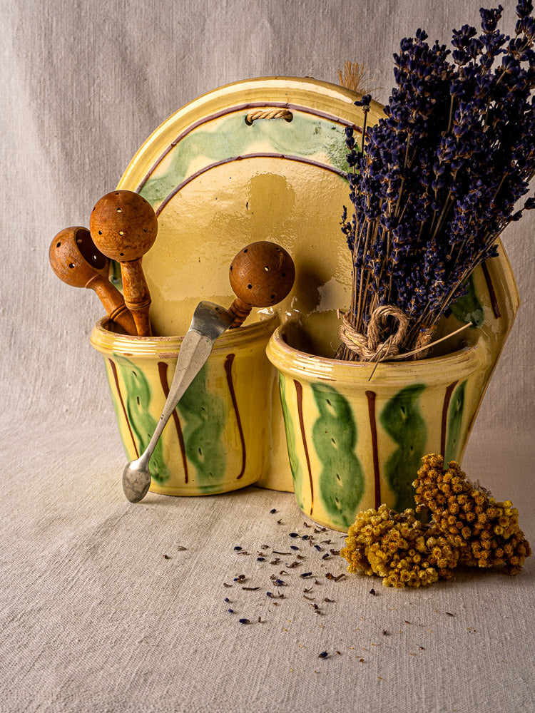 Pair of yellow-green vintage French Cliousclat ceramic cutlery holders with dried lavender and utensils.