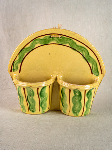 Vintage French Cliousclat terre vernissée cutlery holder with yellow glaze, wavy accents, rope loop; fabric background.