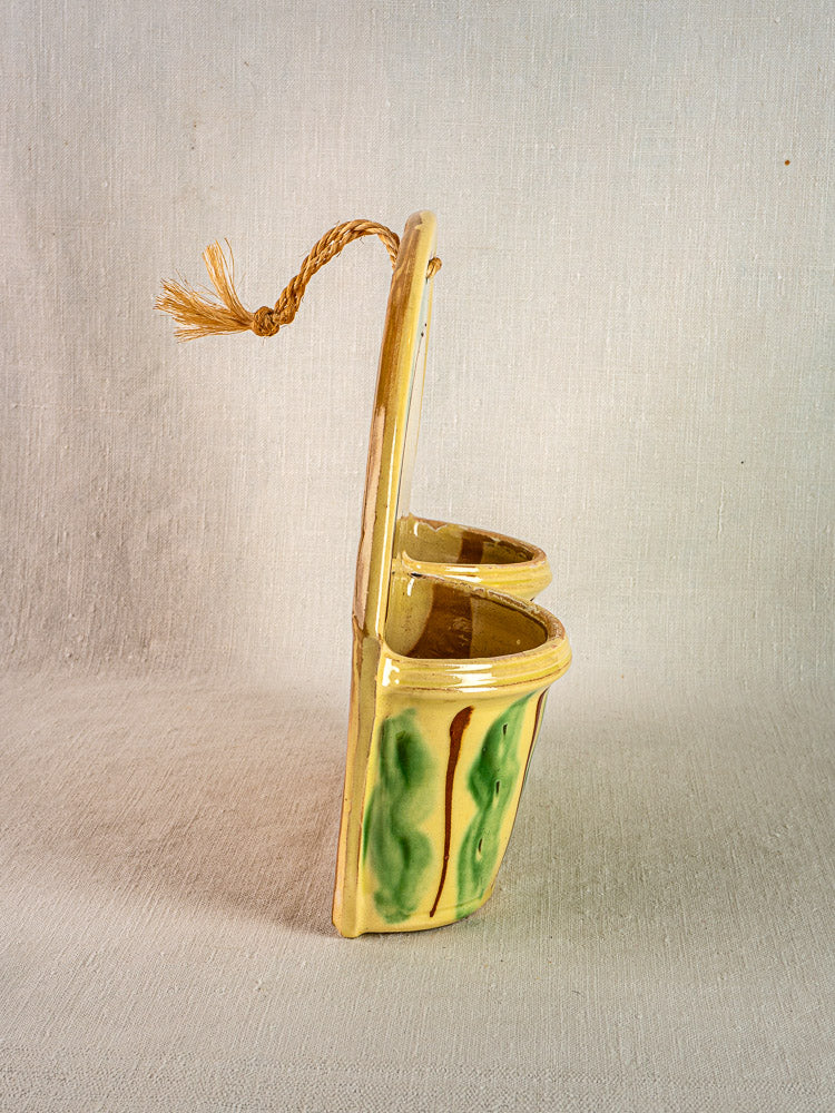 Vintage French Cliousclat cutlery holder in glazed terre vernissée with green, yellow, and brown stripes on fabric.