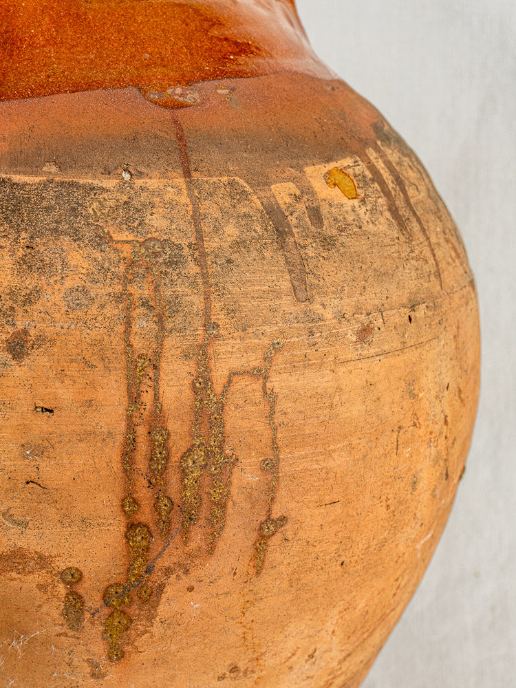 Antique French Auvergne terracotta oil jar with original cork, rich brown and orange patina.