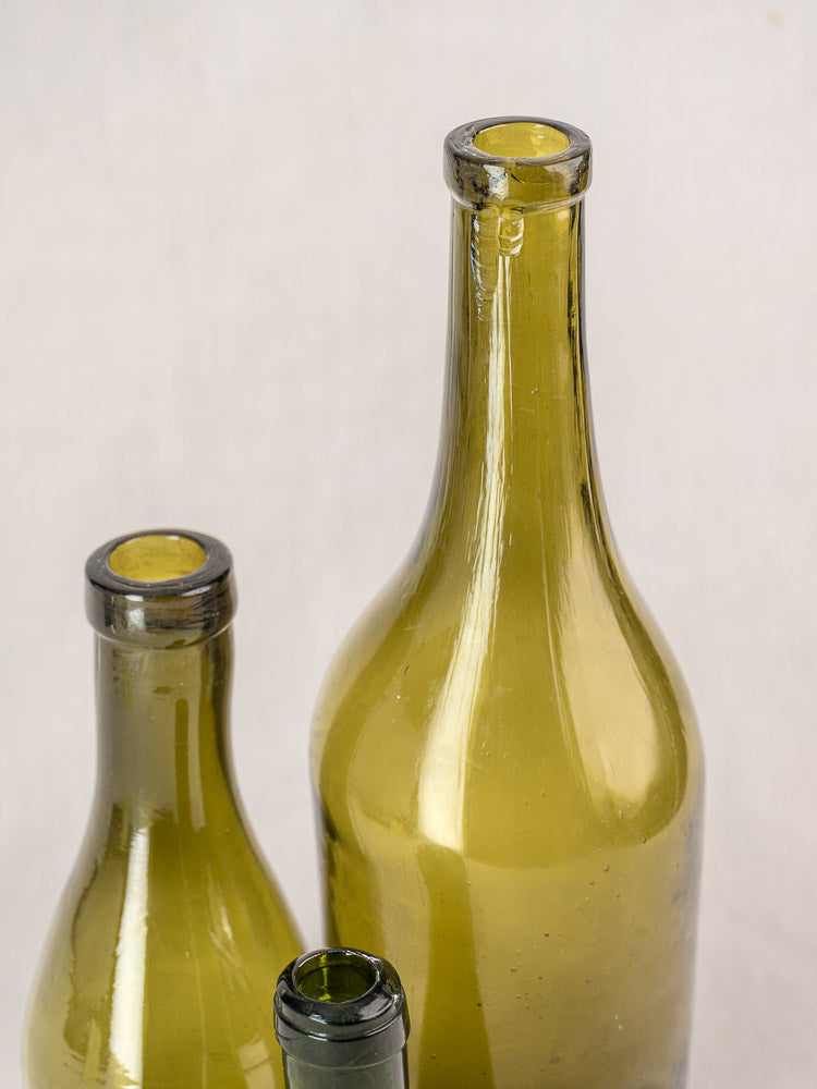 Set of three mid-19th century antique French hand blown olive green glass wine bottles.