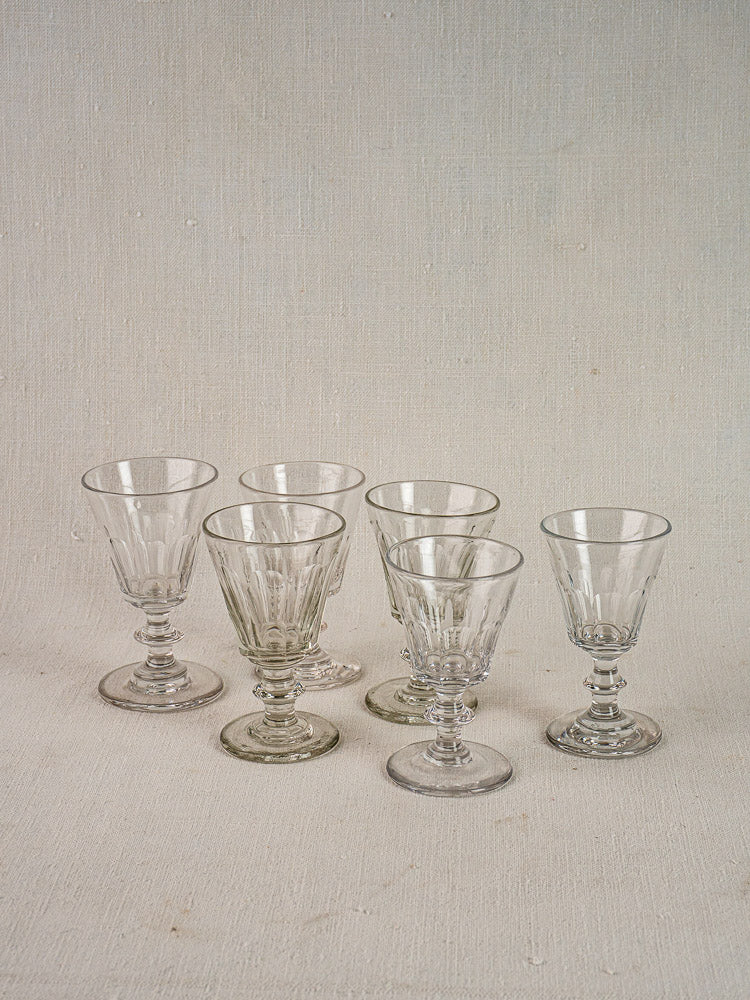Six French hand-cut uranium Ouraline crystal wine glasses displayed in two rows.