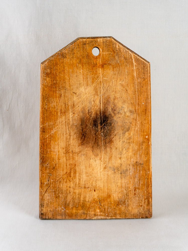 Antique 19th-century French Tombstone Cutting Board with angled corners, aged patina, and visible use marks.