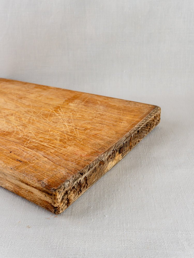 French Tombstone Cutting Board, antique 19th century, with visible scratches and rough edge on light textured surface.